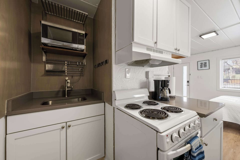 The cozy kitchen offers ample storage space & all the comforts of home​