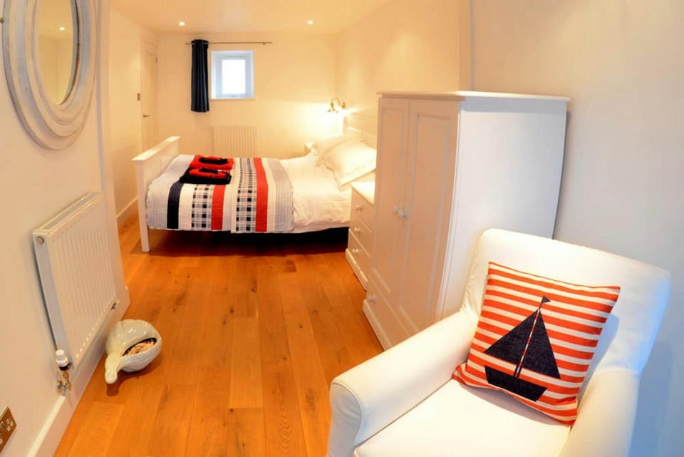 King size bedroom with armchair and wardrobe
