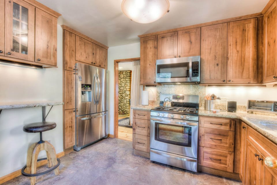 Full kitchen w/ modern appliances: toaster, crockpot, drip coffee maker, wine ware, spices, foil, and much more!