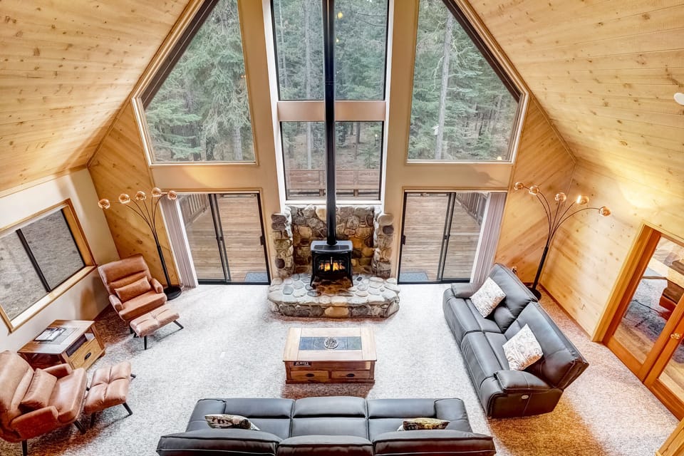 Living room with floor to ceiling windows, gas fireplace, and balcony access