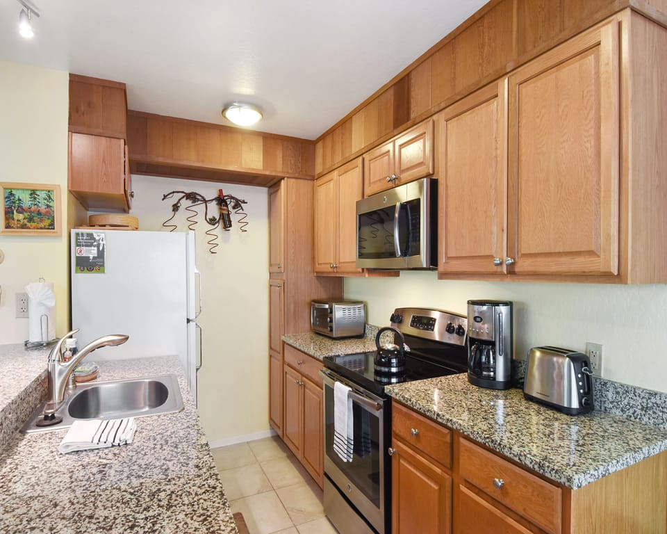 Kitchen with drip coffee pot, toaster, toaster oven, and more