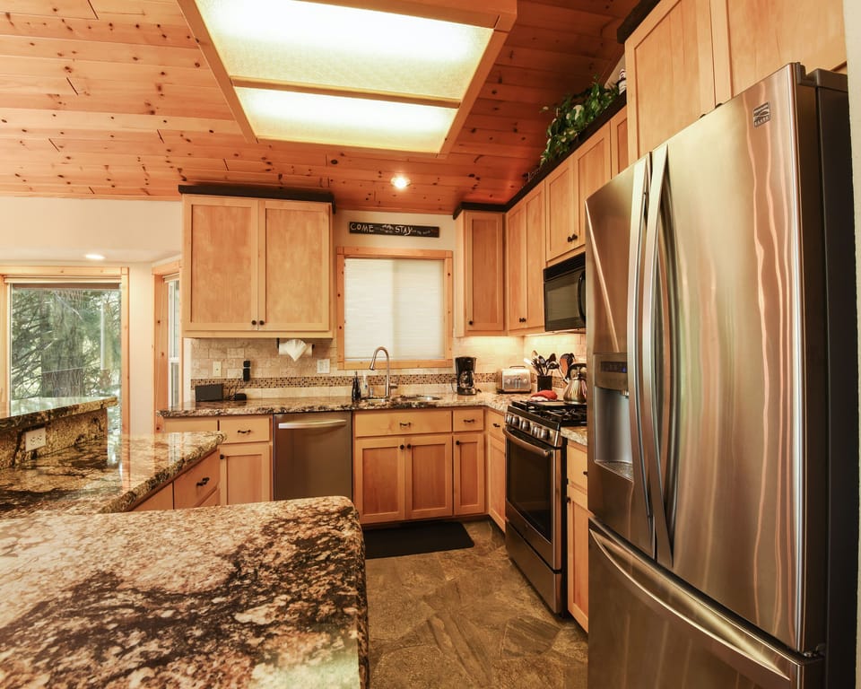 Kitchen with toaster, drip coffee maker, gas stove top, and more