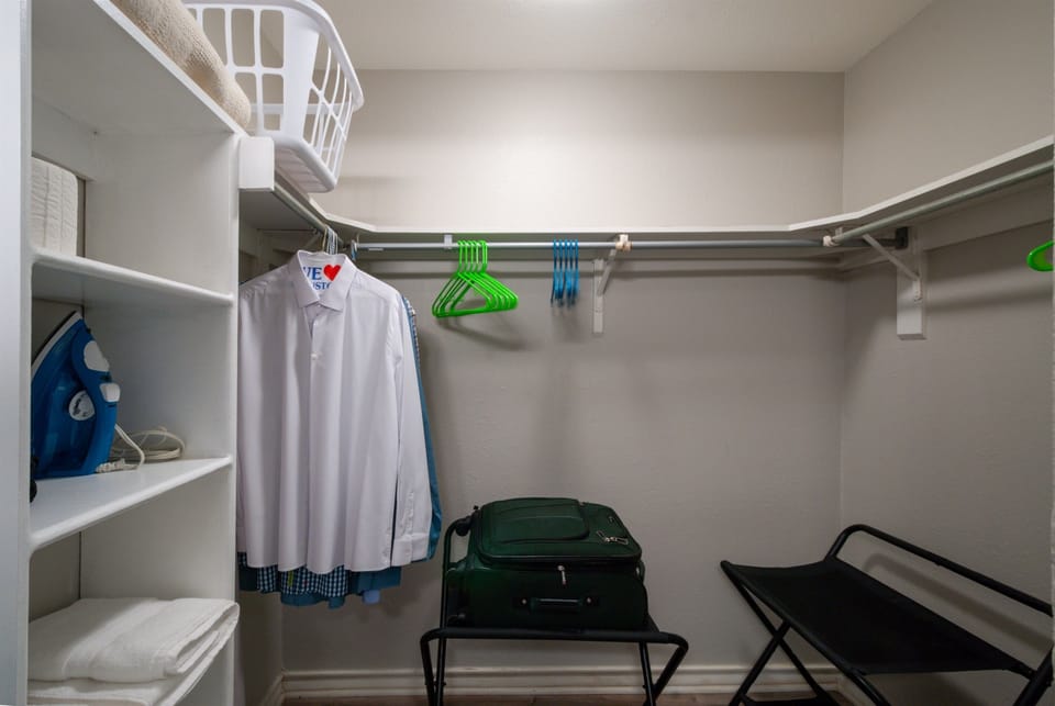 Large bedroom closet with plenty with storage.