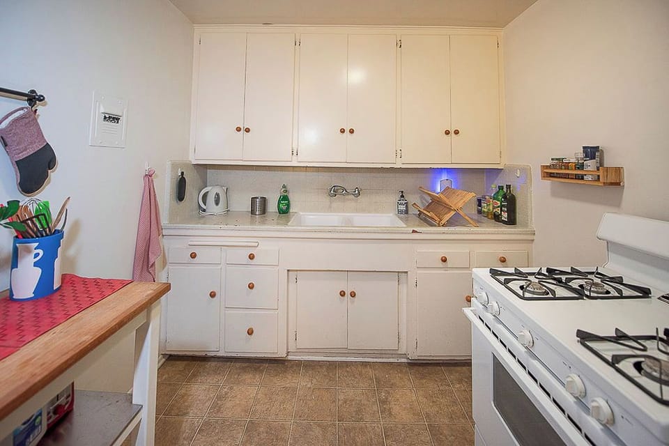 Fully equipped kitchen with four-burner stove and oven, toaster & full fridge.
