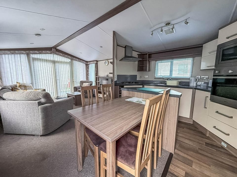 Bright open living and dining area with panoramic windows