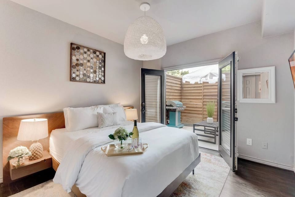 The comfy queen bed, dressed in luxurious Egyptian linen sheets, awaits you in a serene room with French doors that open up to your private patio, offering a peaceful retreat.