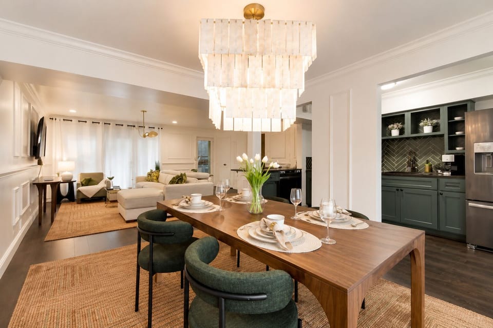 Open dining area with seating for four, featuring a beautiful chandelier..