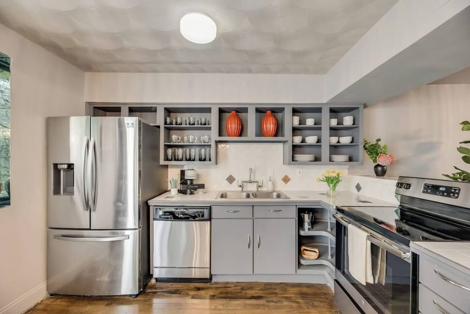 Cook and dine in style with sleek, modern appliances and an open-concept layout. The kitchen is fully stocked for all your needs, plus bar seating for casual meals or socializing.