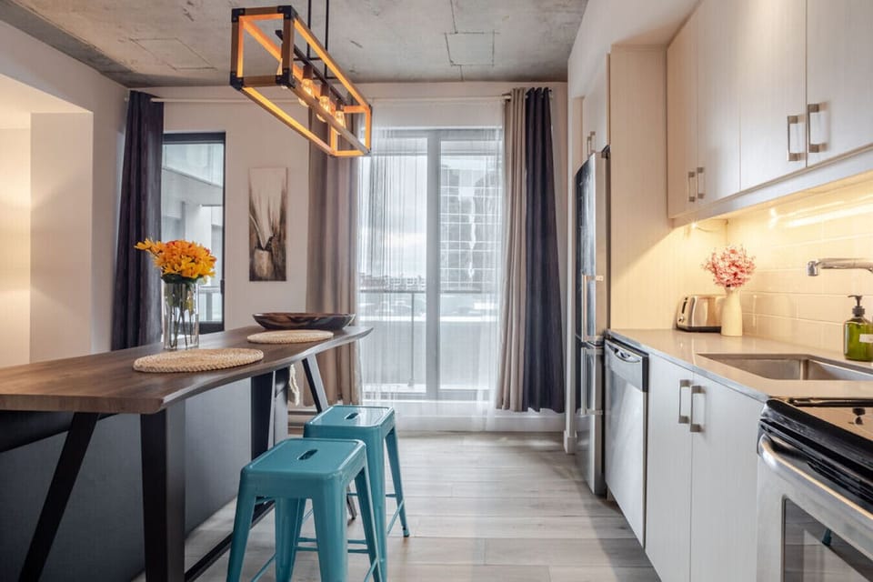 Stylish kitchen and dining with floor-to-ceiling windows.