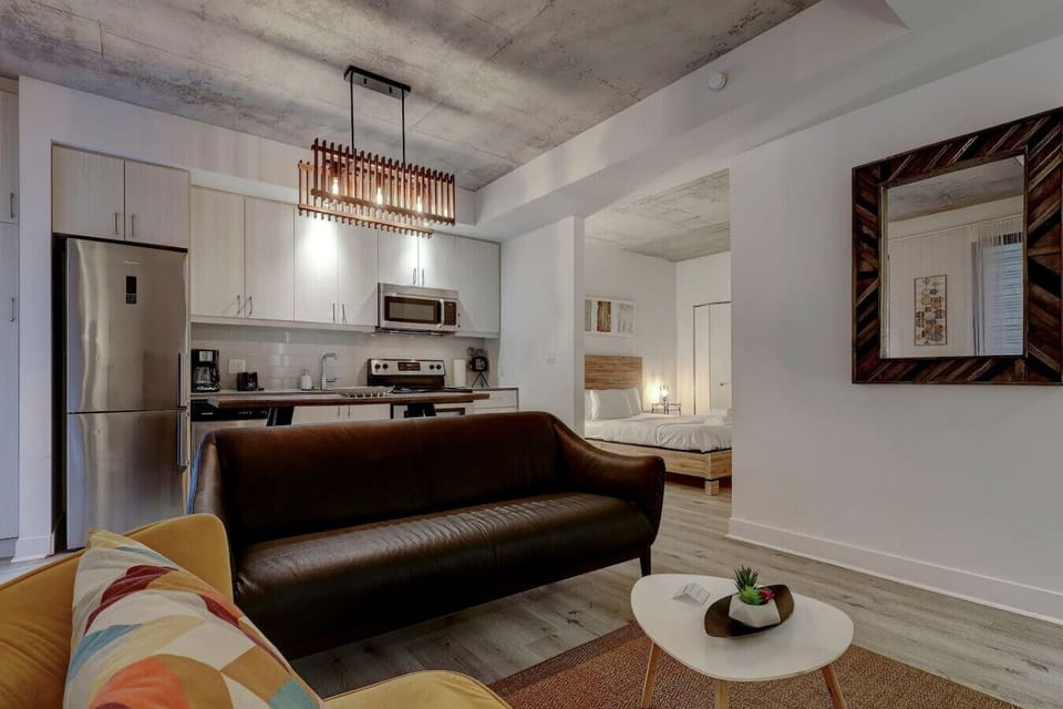 Cozy and contemporary living space with a warm ambiance, accented by bold lighting and a comfortable seating arrangement.