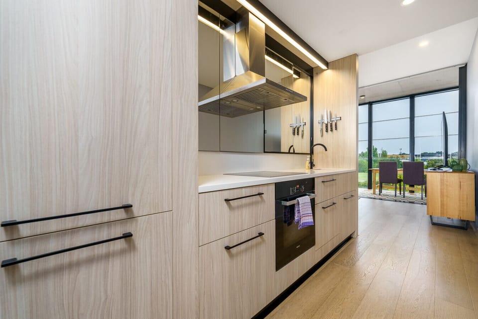 A sleek, modern kitchen featuring all the essential appliances, including a stove, oven, fridge, microwave, and dishwasher, making it perfect for preparing meals with ease and convenience.