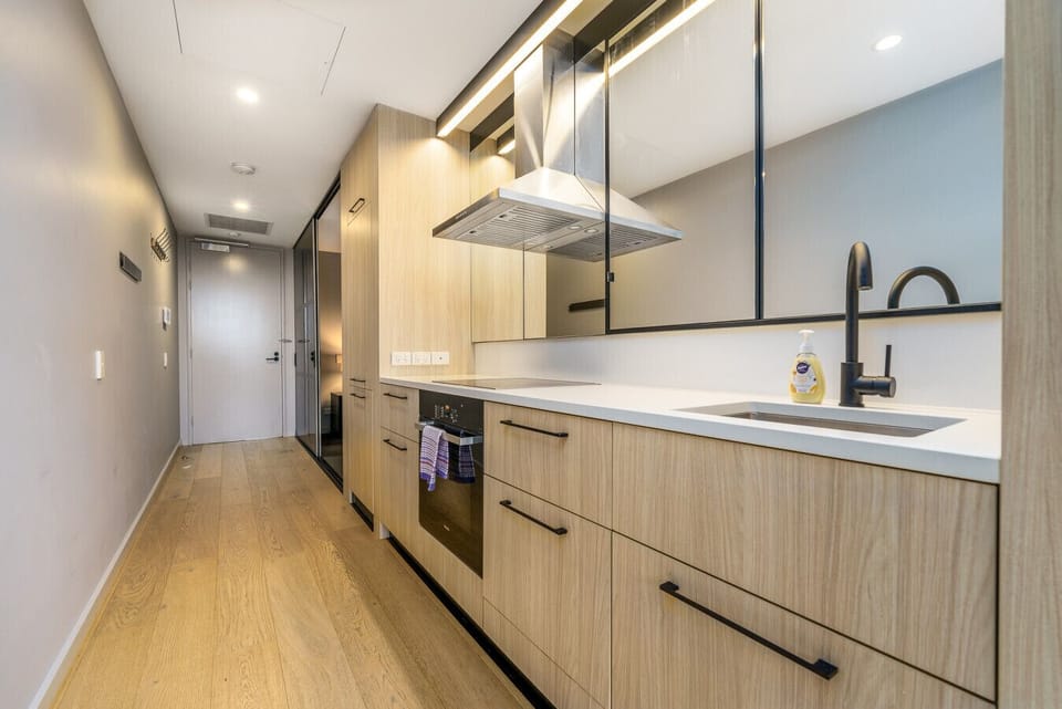A sleek, modern kitchen featuring all the essential appliances, including a stove, oven, fridge, microwave, and dishwasher, making it perfect for preparing meals with ease and convenience.