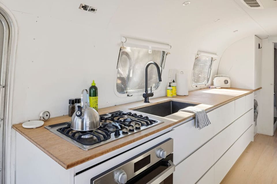 Modern kitchen with stove and countertops.