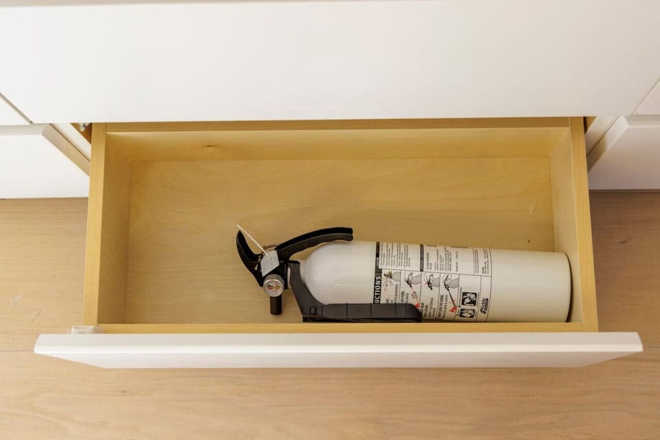 Safety first with a conveniently placed fire extinguisher.  Booking.com i