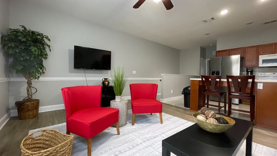 Bright, cozy living room with TV—perfect for movie nights and quick bites from the nearby kitchen!