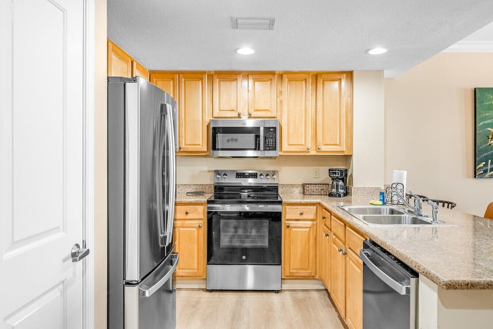 prepare delicious meals in this fully equipped kitchen, featuring stainless steel appliances, granite countertops, and ample cabinet space for all your cooking essentials