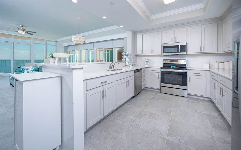 Prepare meals in this kitchen with elegant cabinetry, stainless appliances, and spacious countertops