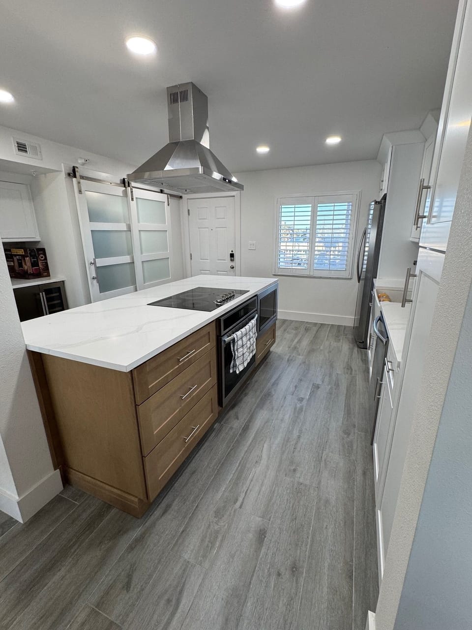 Kitchen with island and enclosed laundry