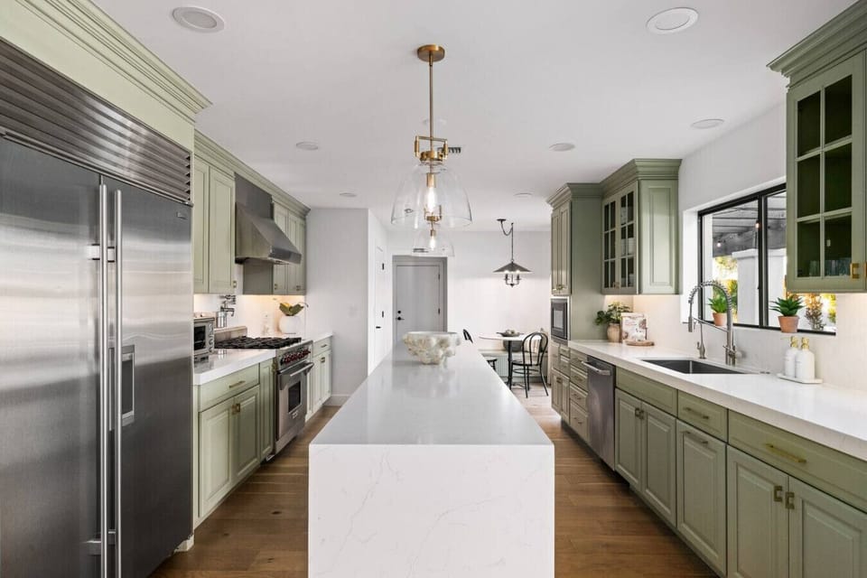 Chef-style kitchen with extended island, premium appliances, and custom cabinetry.