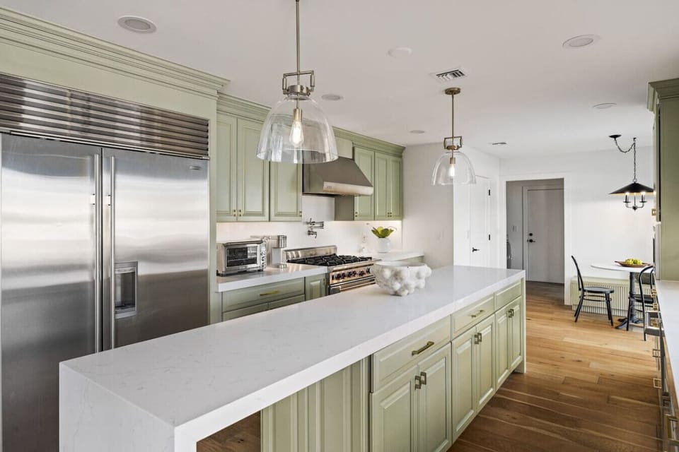 Gourmet kitchen with oversized island, premium appliances, and custom cabinetry.