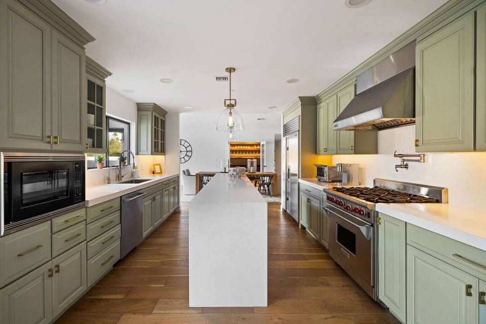 Chef’s kitchen with custom cabinetry, large island, and premium appliances.