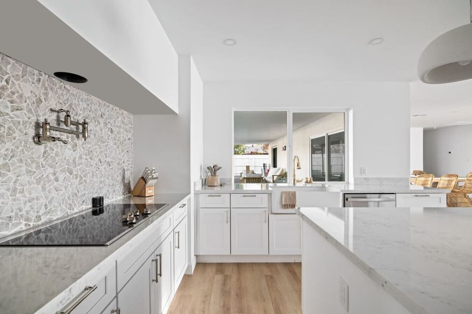 Designer backsplash and statement fixtures that elevate the heart of the home.