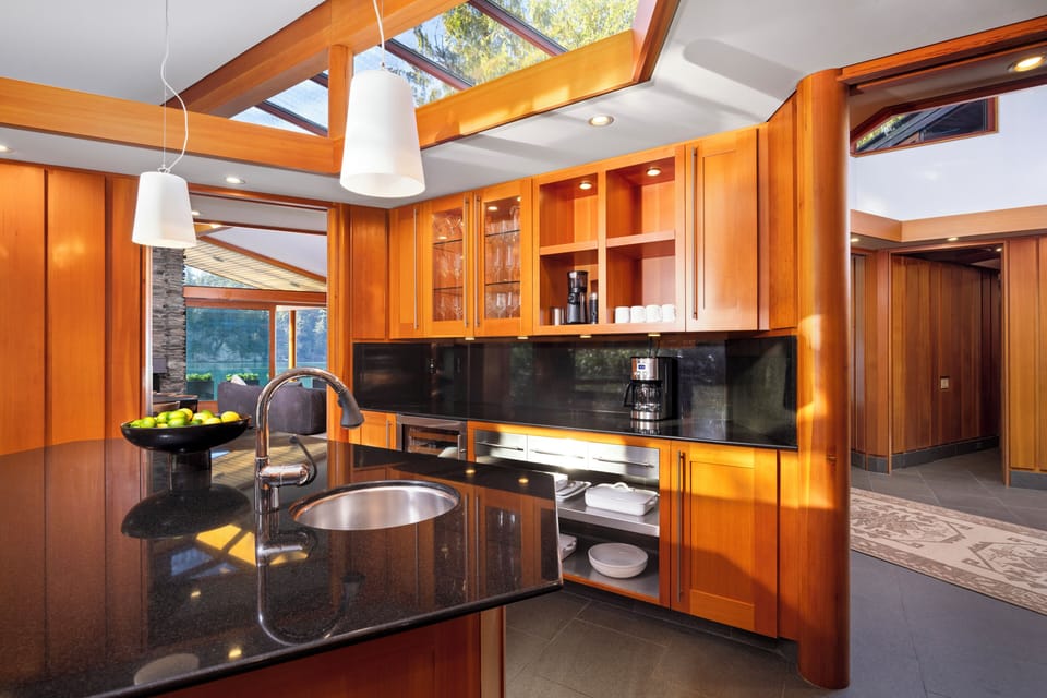 Fully equipped gourmet kitchen with high-end appliances and wood finishes.
