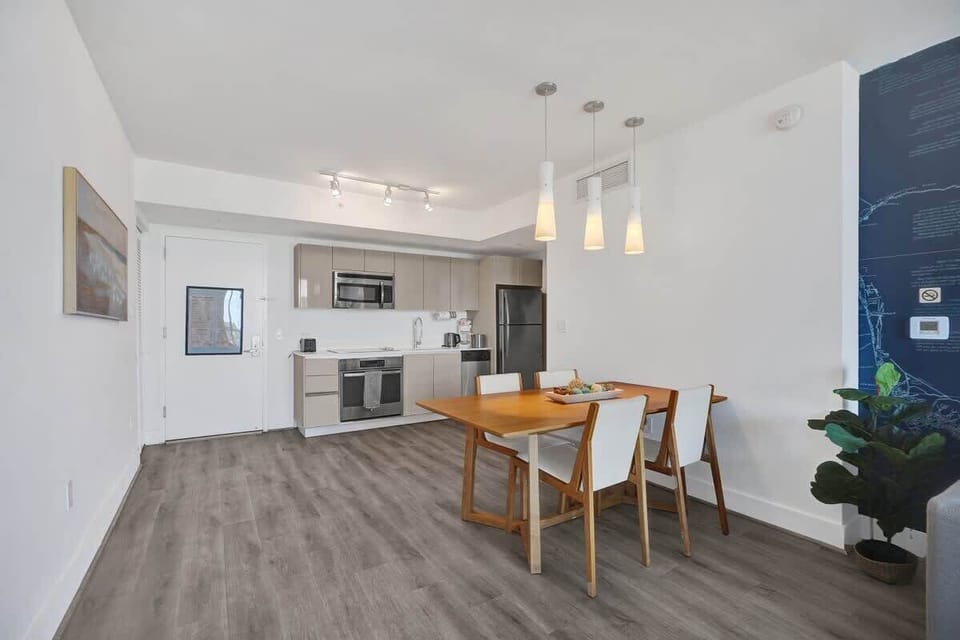 Dining area and fully equipped kitchen with stainless steel appliances