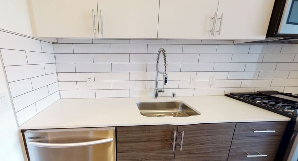 Kitchen with dishwasher, garbage disposal, gas stove, fridge and microwave