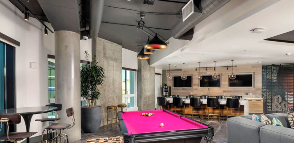 clubhouse with pool table and other games, tvs, and workspace