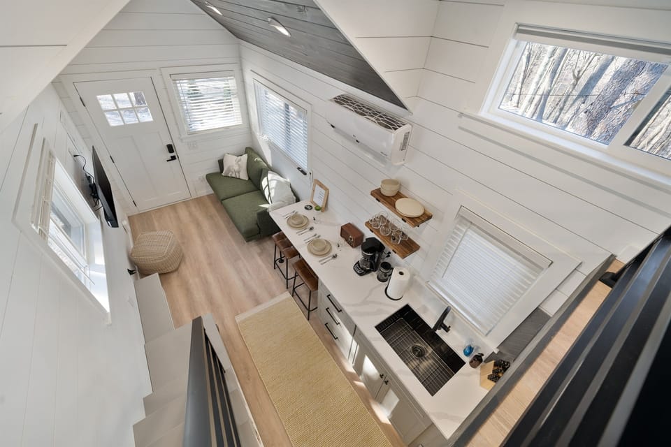 Main floor overview from above at Whitman — open layout, lofted bed visible above, living area below
