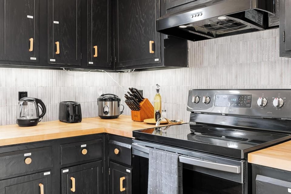 Closer look at toaster, electrical kettle, and rice cooker in full kitchen