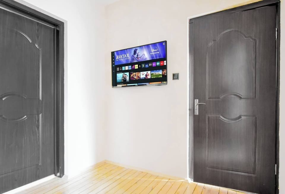 Enjoy entertainment in the living room, featuring a smart TV and a welcoming atmosphere.