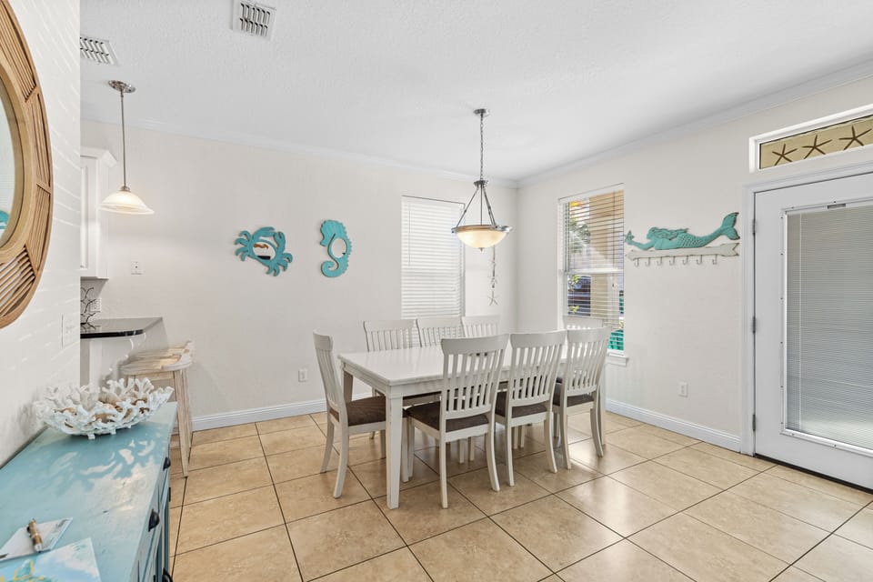 Gather around your bright dining table where coastal charm meets comfort, perfect for shared meals and morning coffee.