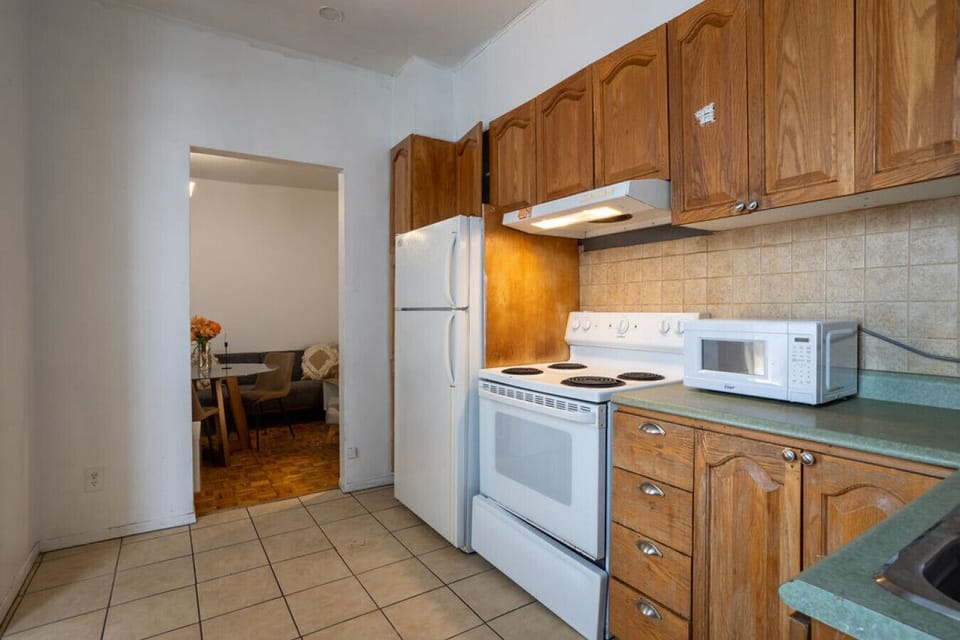 Fully equipped kitchen featuring classic wood cabinetry and modern appliances.