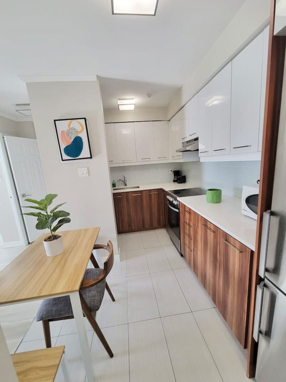 A fully equipped kitchen with high-end appliances, sleek countertops, and a dining area for a convenient and enjoyable stay.