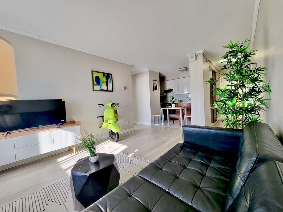 A contemporary open-concept design seamlessly connecting the living area to the kitchen, creating a spacious and inviting atmosphere.