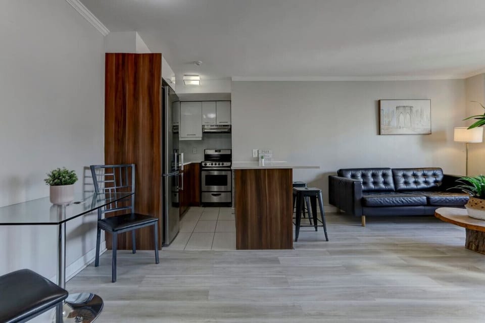 An elegant open-concept space featuring a modern kitchen, cozy dining area, and stylish living room