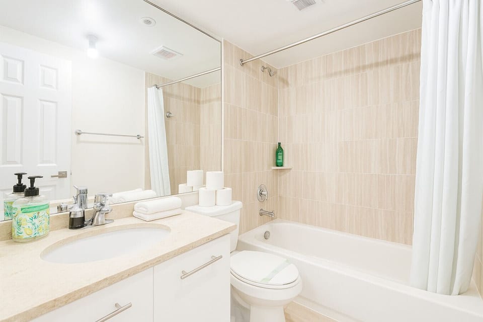 Bathroom: Bright and immaculately clean with a full tub-shower combo, sleek vanity, and spa-like touches for a refreshing reset