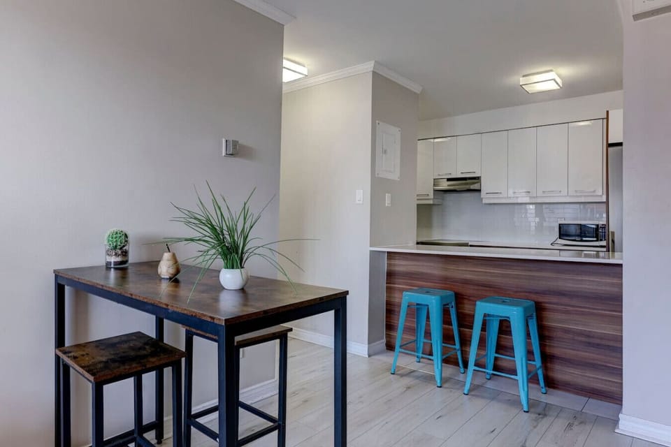 A sleek dining space adjacent to the kitchen, ideal for intimate meals or working remotely.