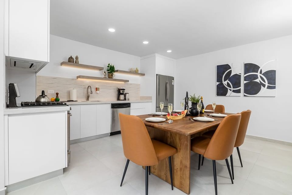 Just steps away, the elegant dining table with seating for six offers a sophisticated yet welcoming ambiance—ideal for intimate family dinners or socializing with friends.