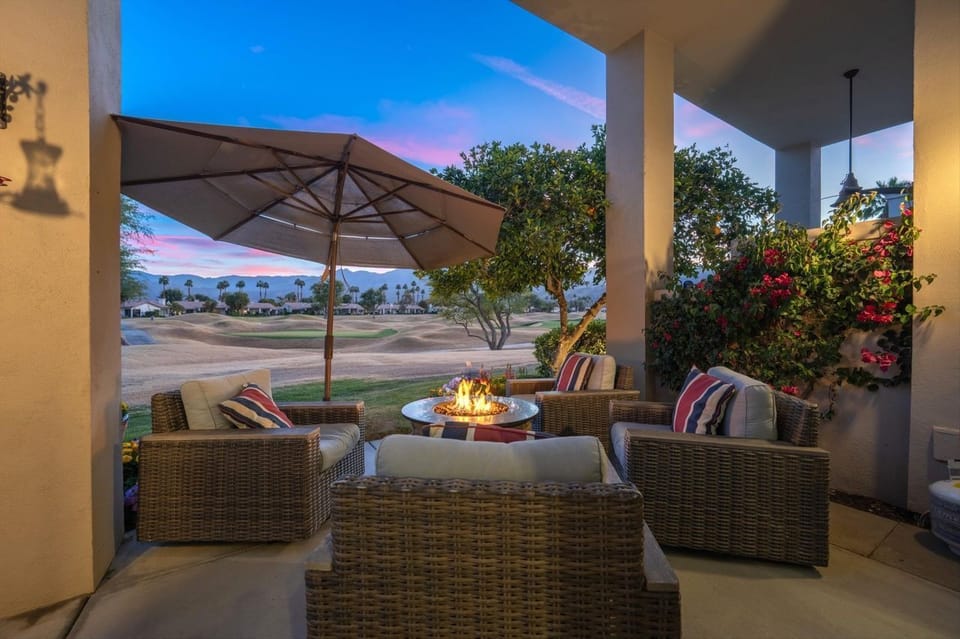Citrus trees frame patio with mountain & golf course views — serene desert oasis