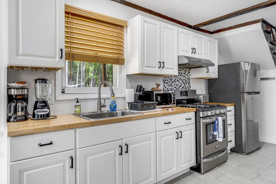 Cook your favorites in a bright kitchen featuring stainless-steel appliances and full cookware.