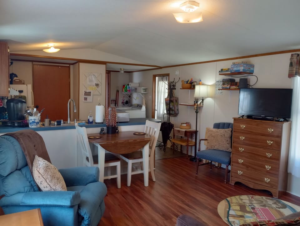 View of living room. Sheets, towels, blanket in dresser, more blankets in chest.