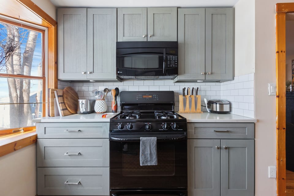  This kitchen maximizes space with its smart layout and stylish gray cabinetry.
