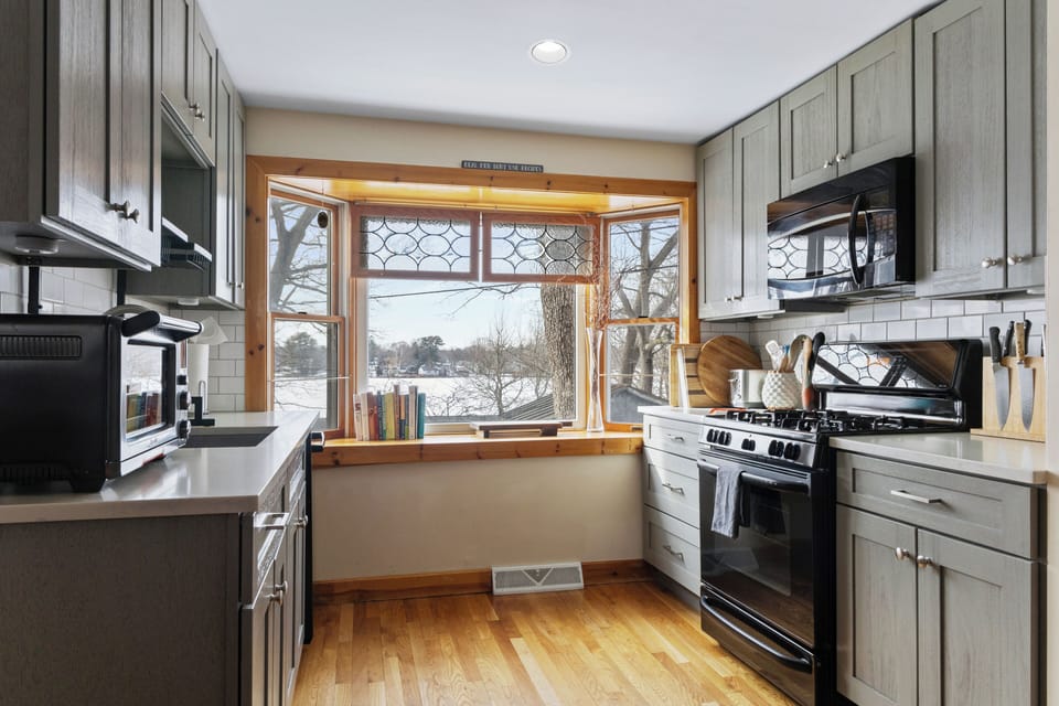 This kitchen maximizes space with its smart layout and stylish gray cabinetry.