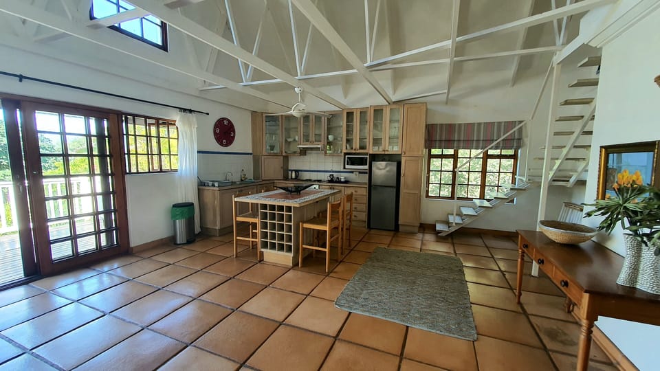 Full kitchen and stairs going up to the 2nd bedroom 