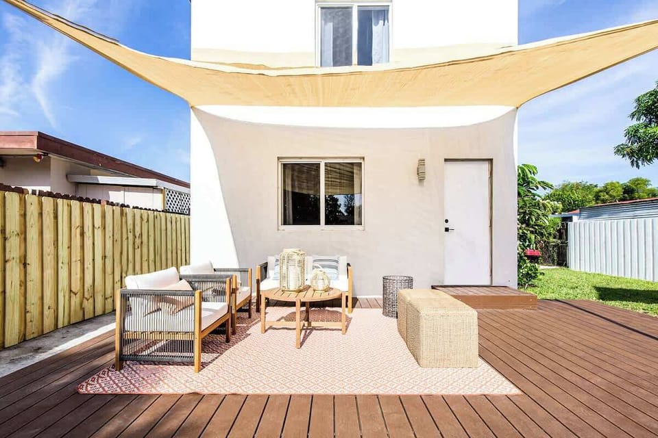 Relax on the poolside patio with comfortable seating and sunny vibes.