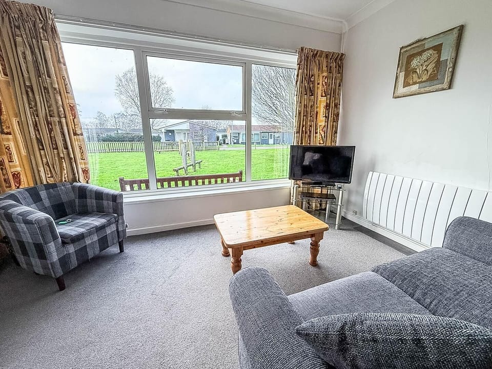 Book your 2026 holidays early to secure your next break and relax in this modern chalet living room.