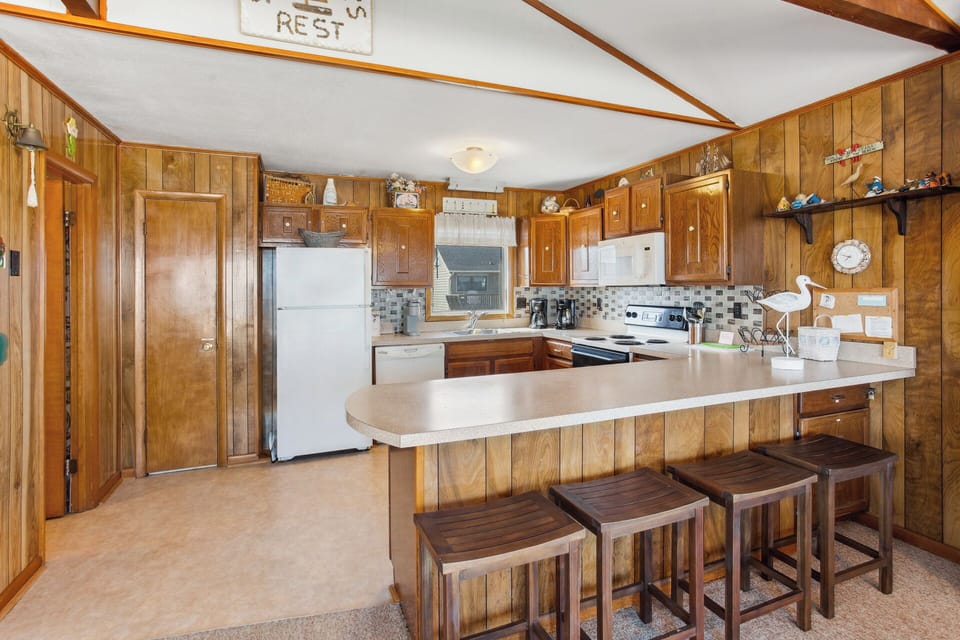 The Kitchen, with counter seating for four, is fully equipped for preparing meals that the whole family will enjoy.